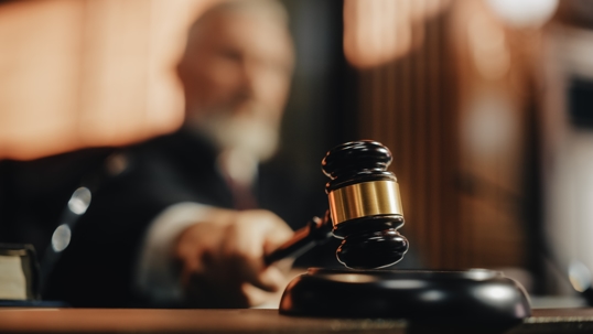 A judge uses a gavel in a courtroom